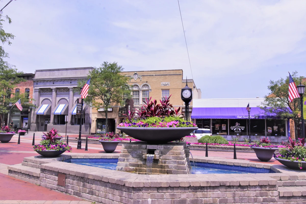 Downtown Northville fountain, clock and storefronts decorated for Independence Day